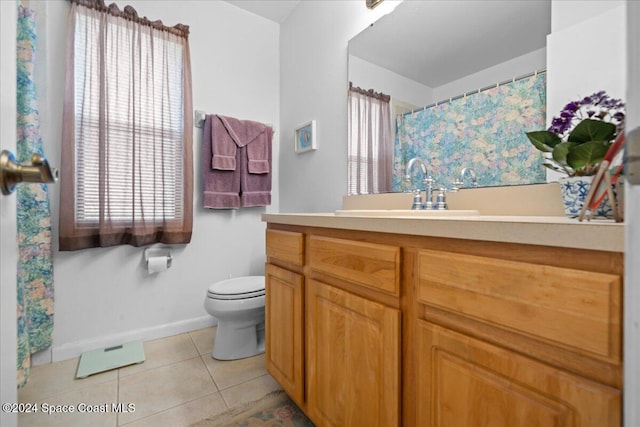 bathroom featuring tile patterned flooring, vanity, and toilet