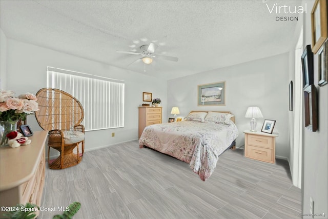 bedroom featuring a textured ceiling, light hardwood / wood-style floors, and ceiling fan