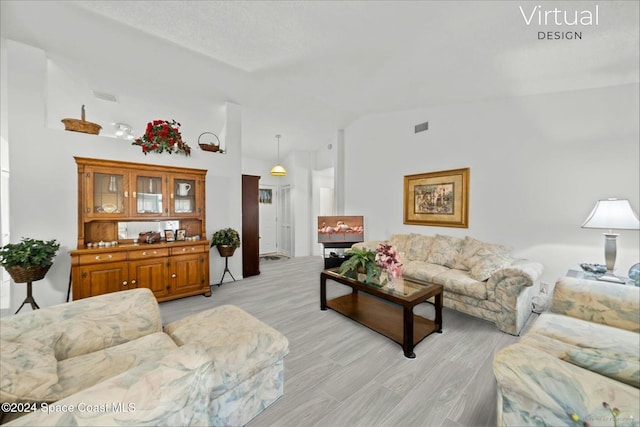 living room featuring light hardwood / wood-style floors and lofted ceiling