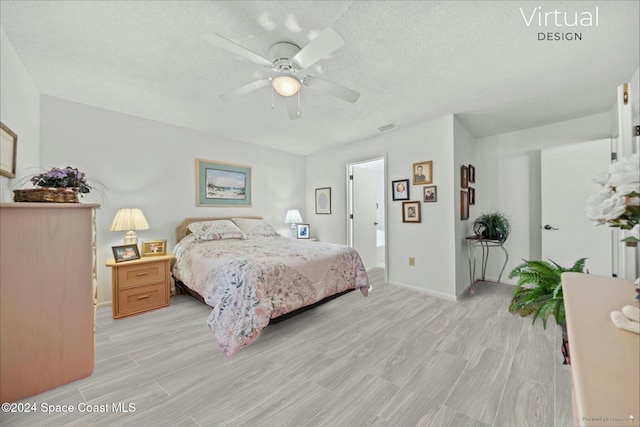 bedroom with ceiling fan, light hardwood / wood-style flooring, and a textured ceiling