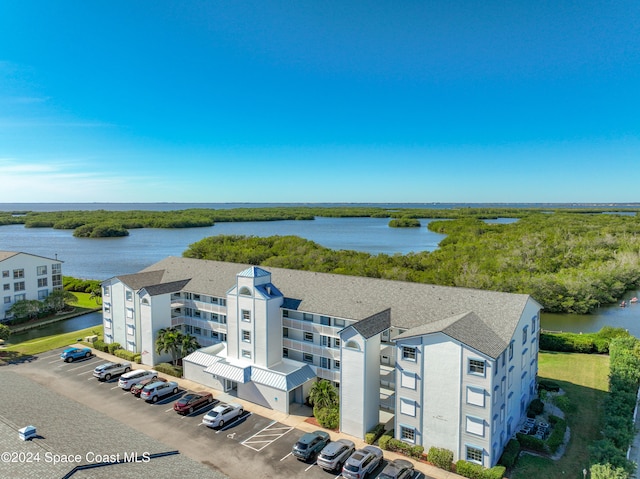 birds eye view of property with a water view