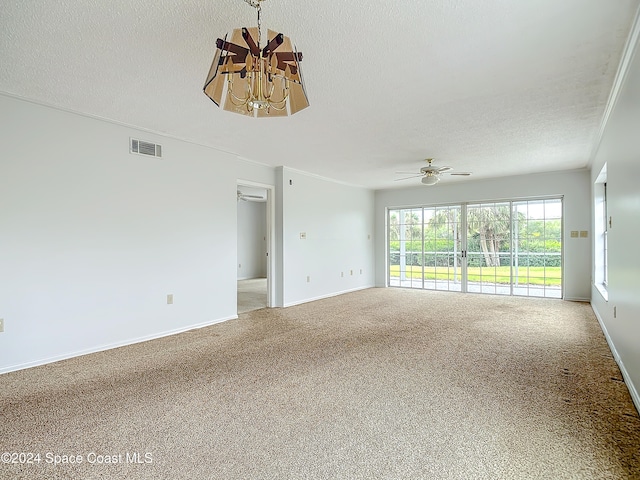 spare room with ceiling fan with notable chandelier, carpet floors, a textured ceiling, and ornamental molding