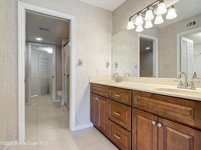 bathroom with tile patterned flooring, vanity, and toilet