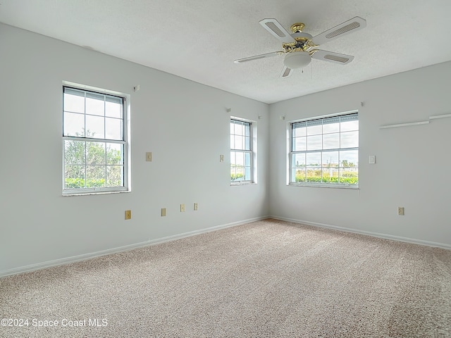 spare room with ceiling fan, carpet, and a textured ceiling