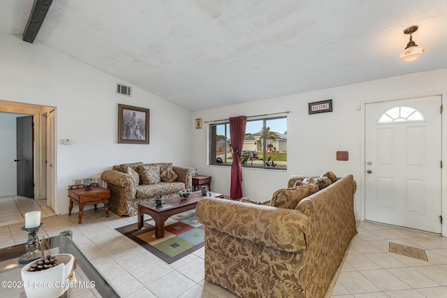 tiled living room featuring lofted ceiling with beams and a textured ceiling