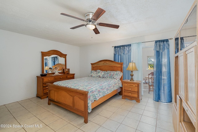 tiled bedroom featuring ceiling fan and a textured ceiling