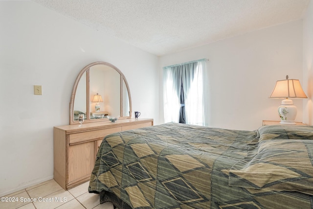 tiled bedroom with a textured ceiling