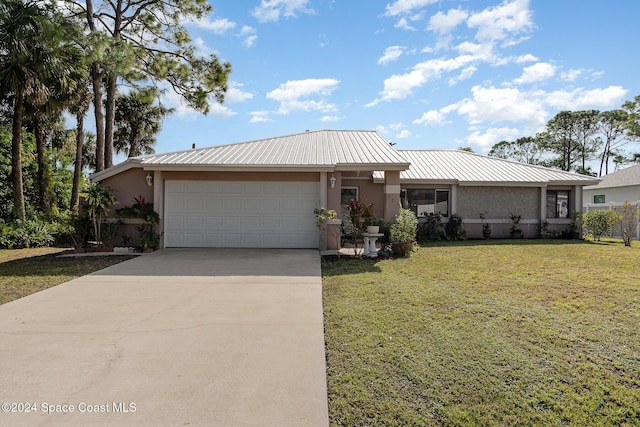 view of front of property featuring a garage and a front lawn