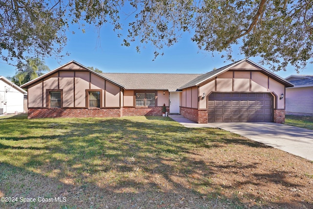 ranch-style house featuring a garage and a front lawn