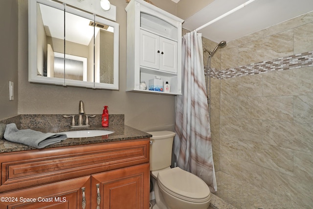 bathroom featuring a shower with curtain, vanity, and toilet