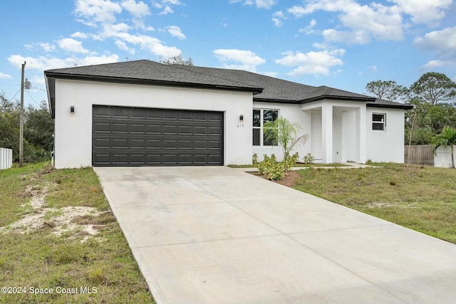 view of front facade featuring a garage and a front lawn