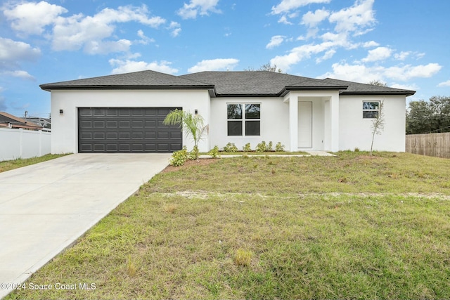 view of front of house with a garage and a front lawn