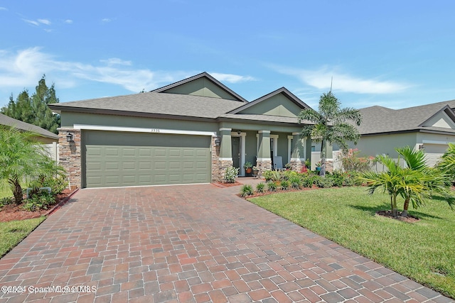 view of front of home with a garage and a front lawn