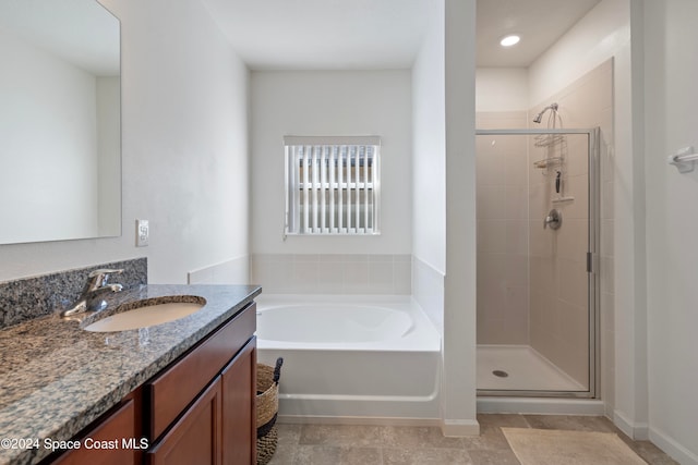 bathroom featuring vanity and shower with separate bathtub