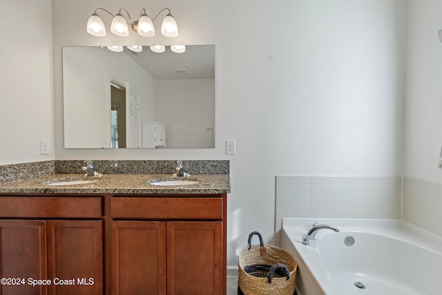 bathroom with vanity and a bathtub