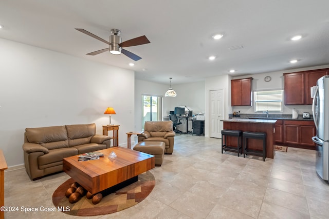 living room with ceiling fan and sink