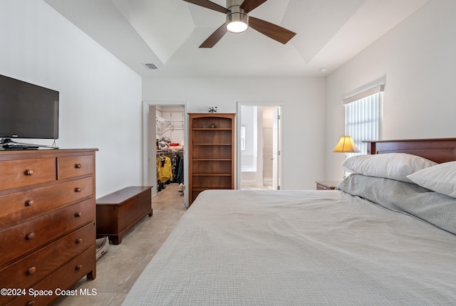 bedroom featuring lofted ceiling, ensuite bathroom, ceiling fan, a spacious closet, and a closet