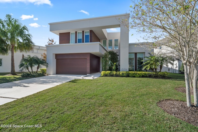 contemporary home featuring a front lawn and a garage