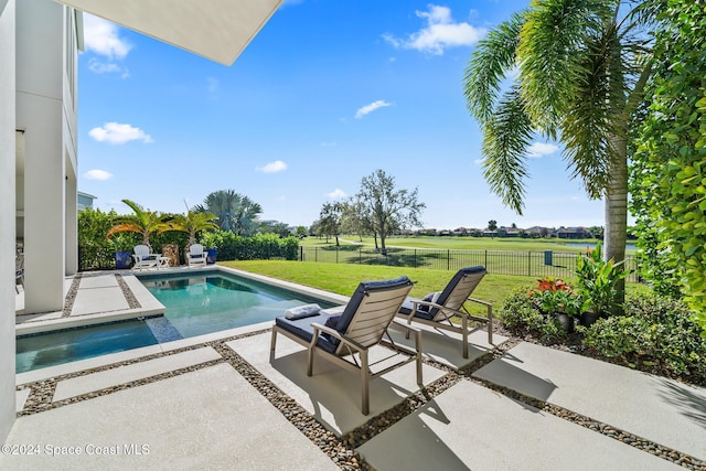 view of swimming pool with a yard and a patio area