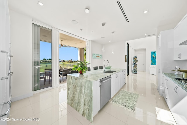 kitchen featuring a center island with sink, white cabinets, and pendant lighting