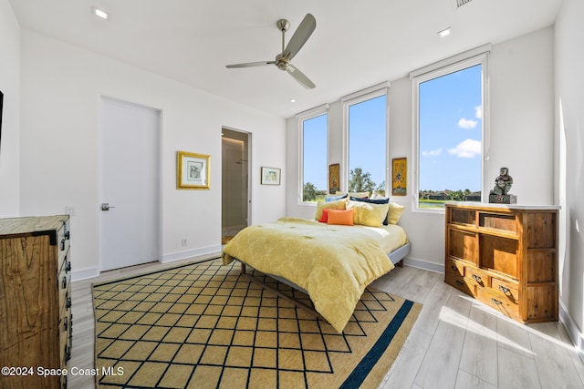 bedroom featuring multiple windows, light wood-type flooring, and ceiling fan