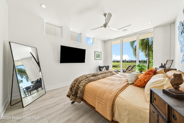 bedroom featuring access to exterior, ceiling fan, and light hardwood / wood-style flooring