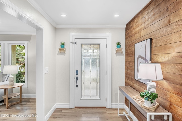 entrance foyer featuring light hardwood / wood-style floors and ornamental molding