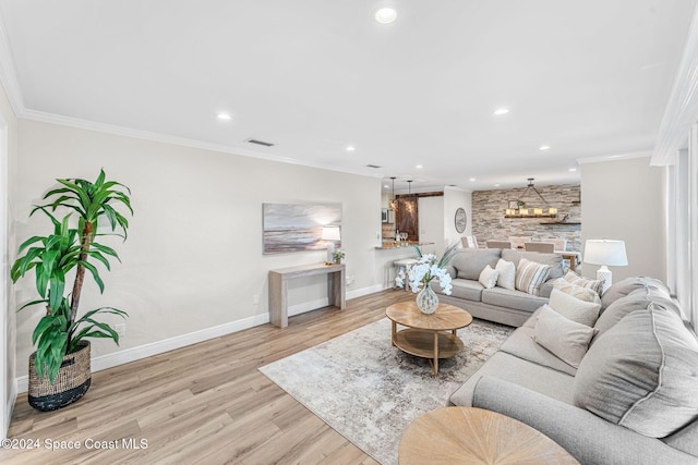 living room with crown molding and light wood-type flooring