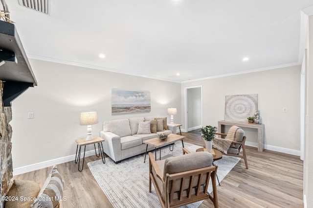 living room with light wood-type flooring and ornamental molding