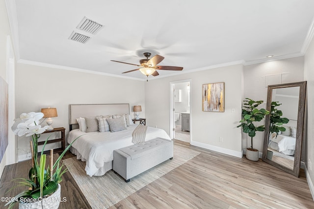 bedroom featuring ceiling fan, ornamental molding, connected bathroom, and light hardwood / wood-style flooring