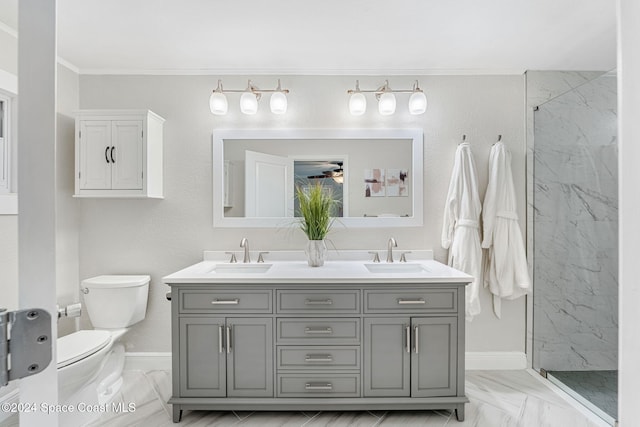 bathroom with vanity, ceiling fan, toilet, and tiled shower