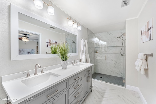 bathroom with ceiling fan, vanity, a shower with shower door, and ornamental molding