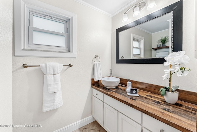 bathroom featuring tile patterned flooring, vanity, and ornamental molding