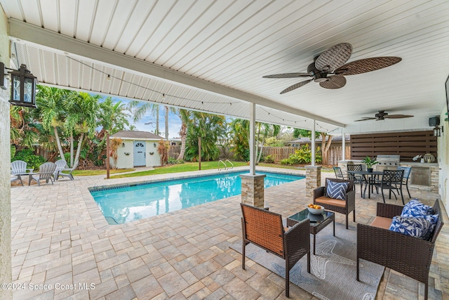 view of pool with outdoor lounge area, a storage unit, ceiling fan, and a patio area