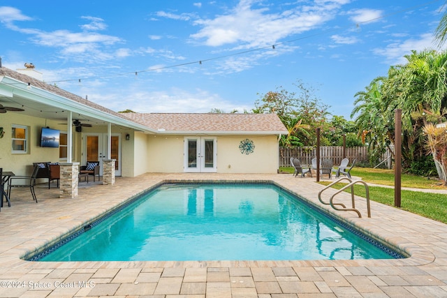 view of pool with ceiling fan, a patio area, and french doors