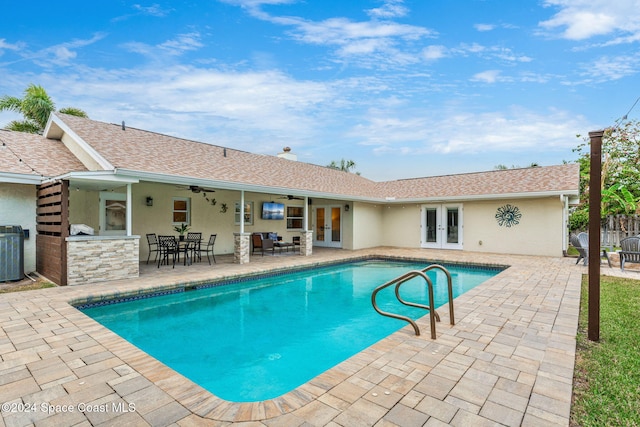 view of swimming pool with central air condition unit, ceiling fan, french doors, and a patio