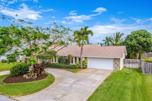 ranch-style home featuring a front yard and a garage