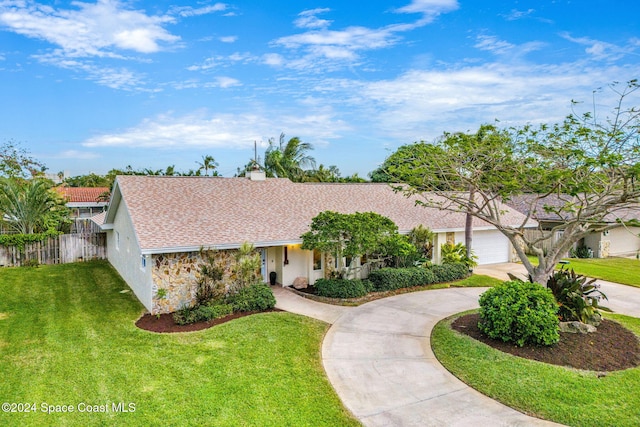 ranch-style home featuring a garage and a front lawn