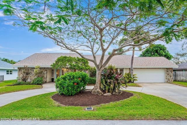 view of front of home with a garage and a front lawn