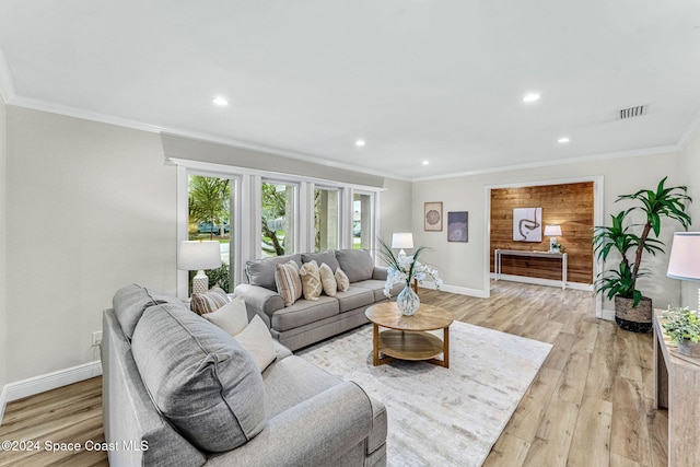 living room with light hardwood / wood-style floors and ornamental molding