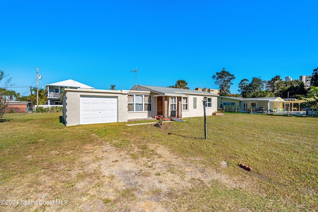 single story home with a garage and a front yard