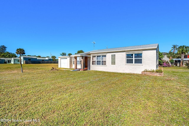 view of front of house featuring a garage and a front lawn