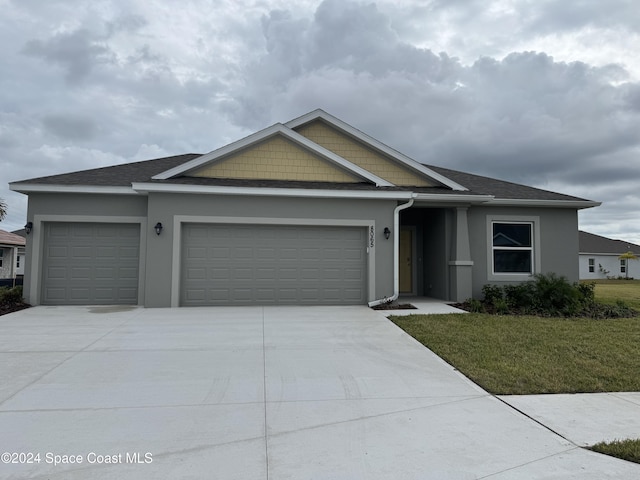 view of front of property featuring a garage and a front yard