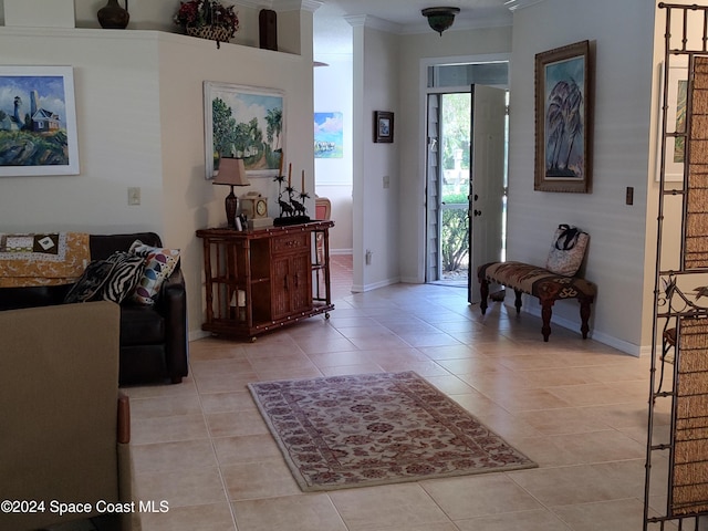 tiled entrance foyer featuring crown molding