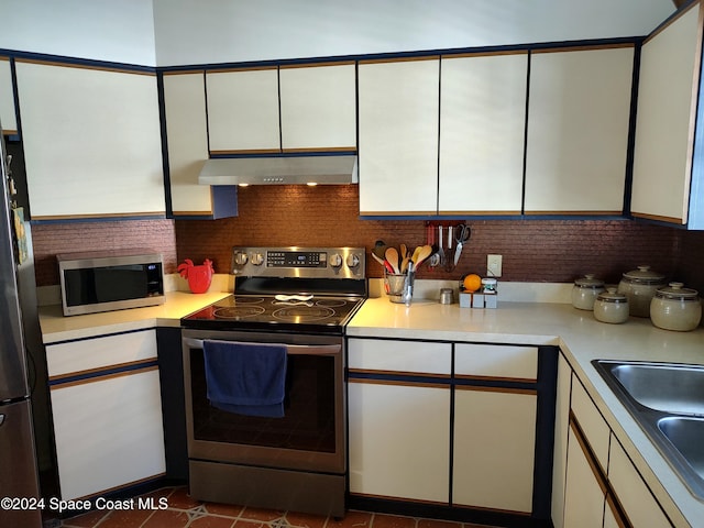 kitchen with ventilation hood, stainless steel appliances, and white cabinetry