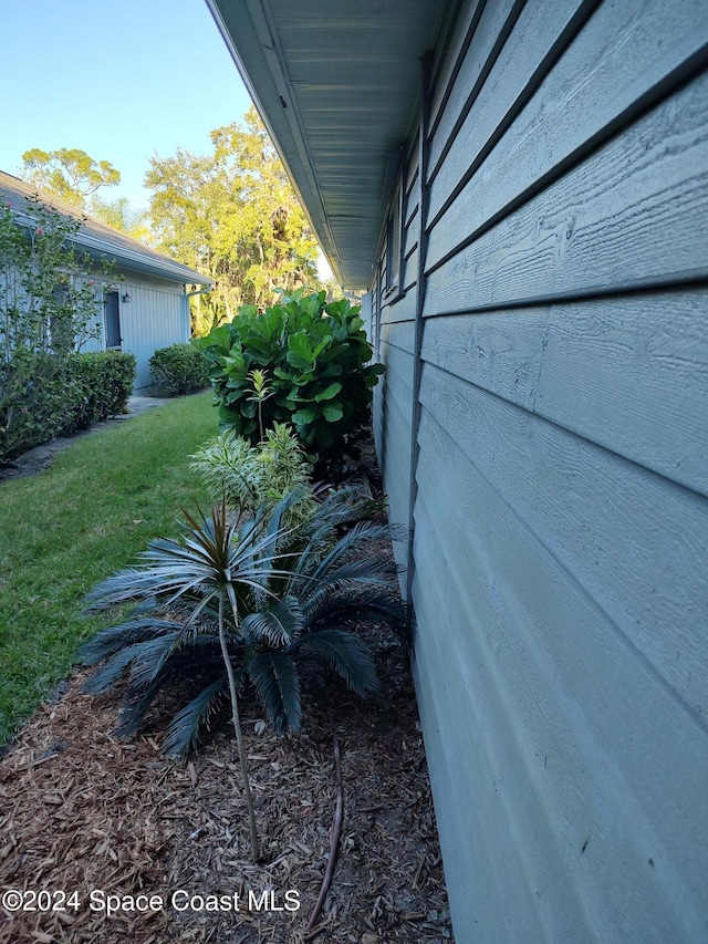 view of side of home featuring a yard