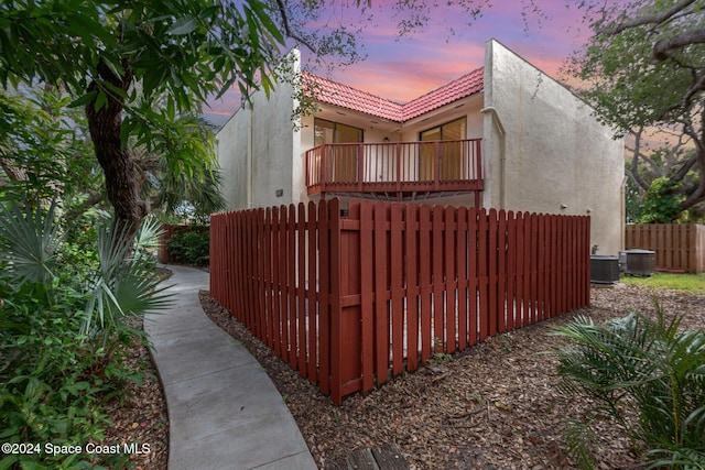 gate at dusk featuring cooling unit