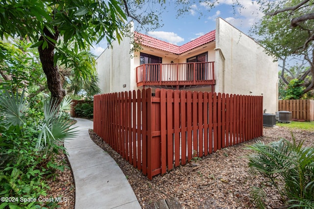 exterior space with a balcony and cooling unit