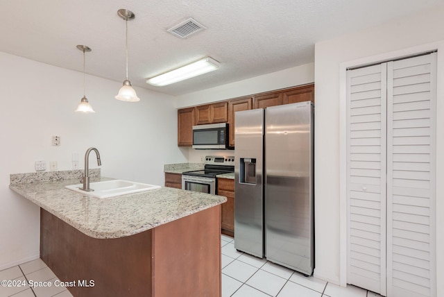 kitchen featuring pendant lighting, sink, light tile patterned floors, kitchen peninsula, and stainless steel appliances