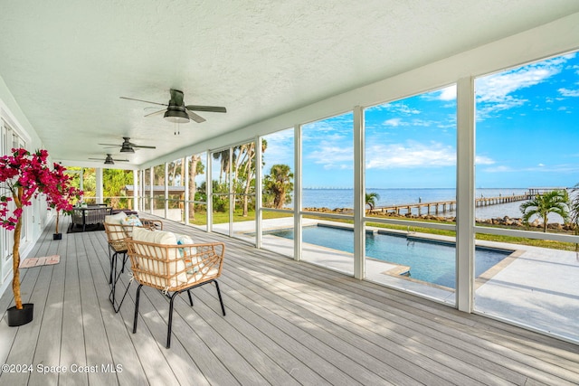 sunroom featuring a water view and a wealth of natural light